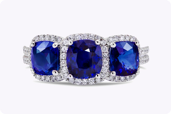 3.25 Carats Cushion Cut Blue Sapphire & Diamond Three-Stone Halo Engagement Ring in White Gold