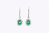 1.95 Carats Oval Cut Emerald & Diamond Halo Dangle Earrings in White Gold