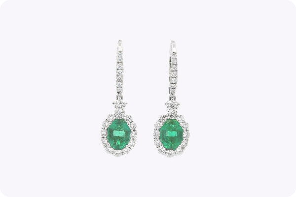 1.95 Carats Oval Cut Emerald & Diamond Halo Dangle Earrings in White Gold