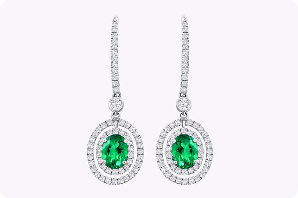 1.01 Carats Total Oval Cut Emerald and Diamond Halo Dangle Earrings in White Gold