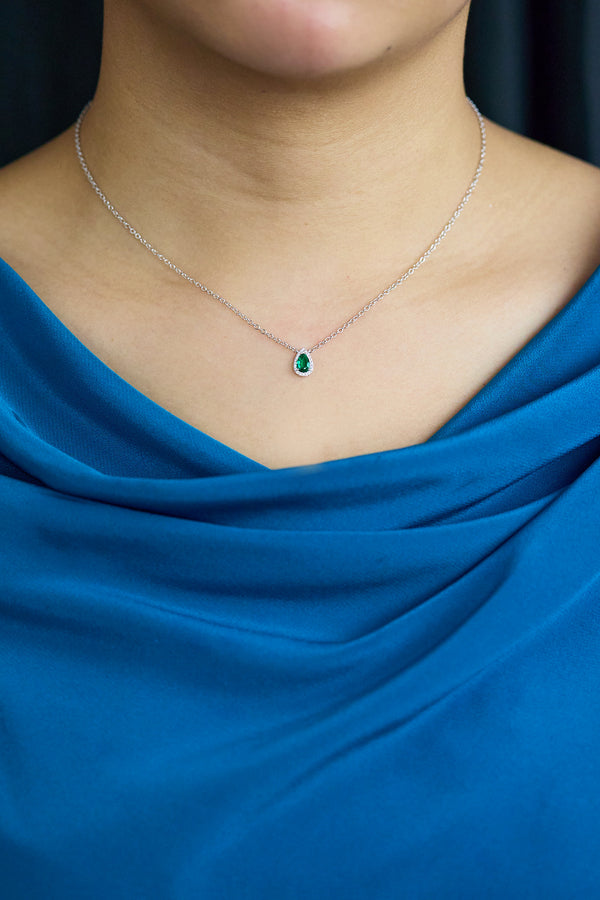 0.34 carat pear-shaped emerald pendant with diamond halo