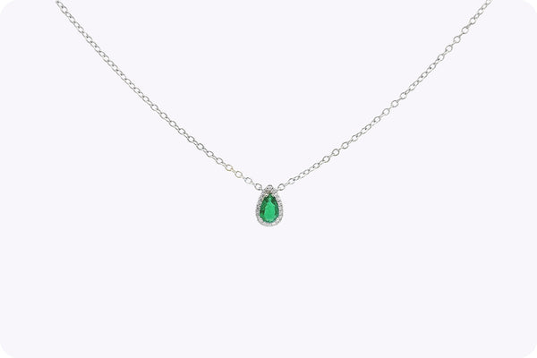 Beautiful 0.34 carat pear-shaped emerald pendant with diamond halo