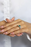 1.64 Carat Total Emerald Cut Green Emerald and Diamond Three-Stone Halo Engagement Ring in Platinum