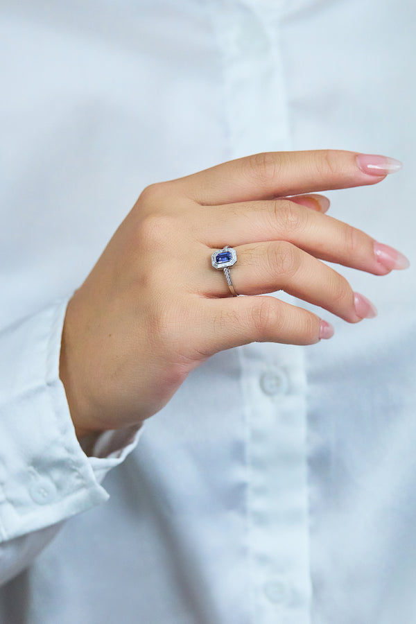 0.69 Carat Emerald Cut Sapphire & Baguette Halo Engagement Ring in Platinum