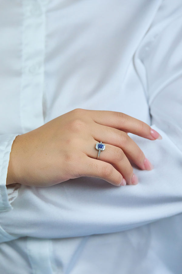 0.69 Carat Emerald Cut Sapphire & Baguette Halo Engagement Ring in Platinum