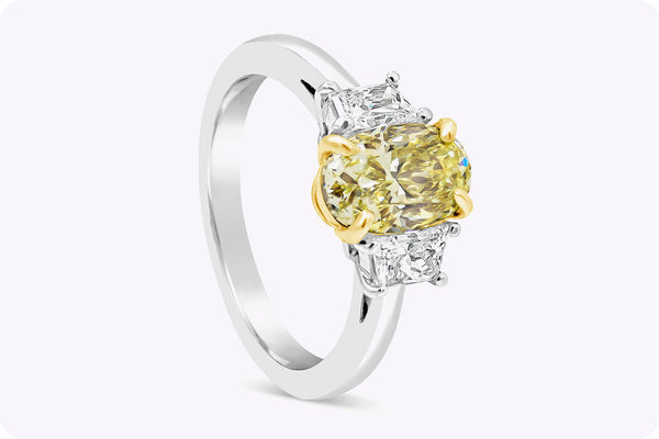 GIA Certified 1.57 Carats Oval Cut Yellow Diamond Three-Stone Engagement Ring in Yellow Gold & Platinum