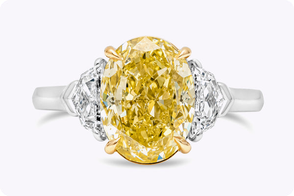 GIA Certified 4.12 Carats Oval Cut Yellow Diamond Three-Stone Engagement Ring in Yellow Gold & Platinum