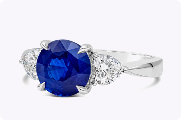 2.77 Carats Round Cut Blue Sapphire Three-Stone Engagement Ring in Platinum