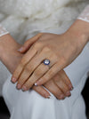 Diamond halo blue sapphire engagement ring worn