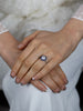 Diamond halo blue sapphire engagement ring worn