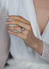 Diamond halo blue sapphire engagement ring worn