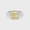 GIA Certified 1.50 Carats Oval Cut Yellow Diamond Three-Stone Engagement Ring in Yellow Gold & Platinum