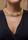 This collar style wide Cuban necklace design is made in 14 karat yellow gold