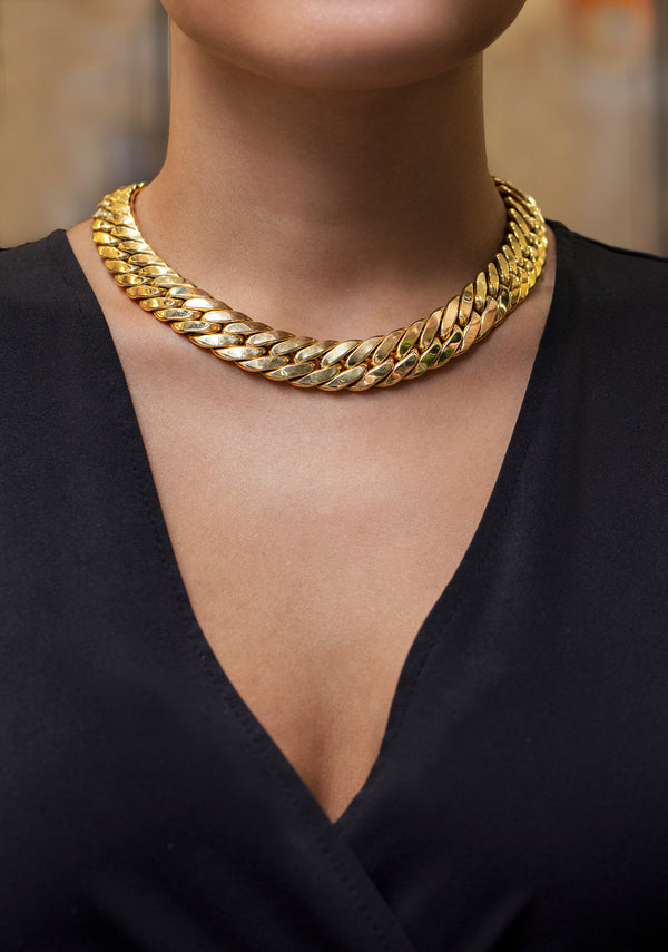 This collar style wide Cuban necklace design is made in 14 karat yellow gold