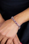 10.15 Carats Total Oval Cut Ruby and Diamond Flower Tennis Bracelet in White Gold